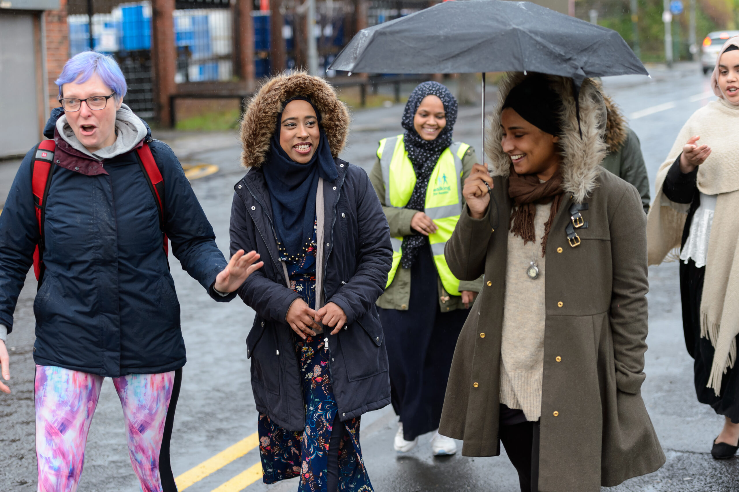 Womens walking group, chatting and walking on a rainy day.